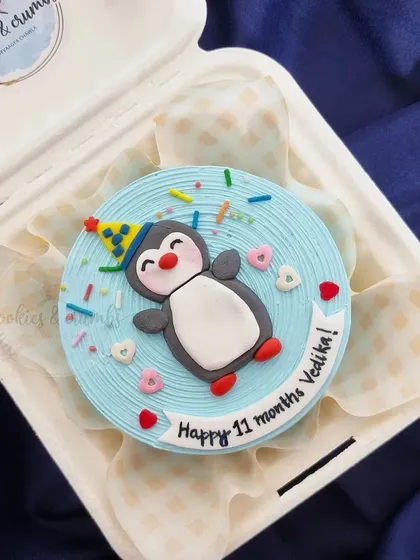 Celebrating a baby's 11-month milestone with this adorable penguin bento cake. The little party hat and colorful sprinkles make it extra festive.