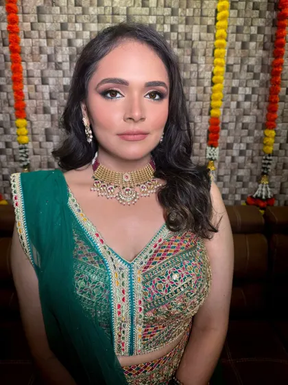 A portrait of a client ready for her Mehendi in a gorgeous multi-colored embroidered blouse and green dupatta.