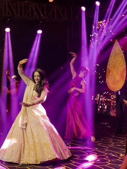The purple lighting and graceful movements make this a stunning visual. We coordinate with the lighting team to create the perfect mood for each performance.