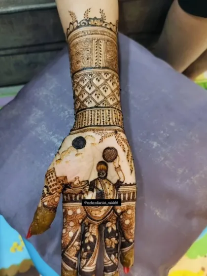 A special mehendi for the Karwa Chauth festival, featuring a portrait of a woman looking at the moon through a sieve, which is a central ritual of the day.