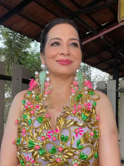 The front view of the carnival look. The hair is pulled back neatly to let the colorful outfit and statement earrings do the talking. It’s a balanced and joyful look.