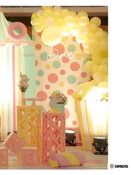 A close-up of the candyland decor, featuring a popcorn-box-style backdrop, decorative pedestals, and 'ONE' blocks.