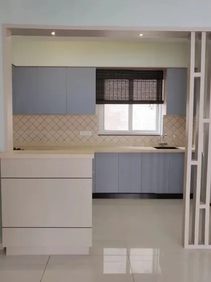 An open-concept view of the kitchen, framed by a stylish partition. The design feels airy and connected to the rest of the home.