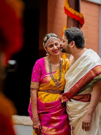 A stolen kiss amidst the celebration. These spontaneous moments of affection are what make wedding stories so special and real.