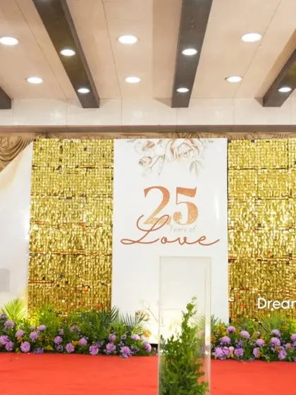 Another view of the 25th-anniversary stage, showing the full setup with the red carpet and marquee numbers.