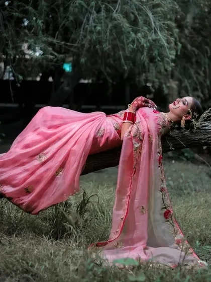 A joyful and relaxed pose, with the model laughing while lying on the tree log. This candid moment captures a feeling of freedom and happiness.