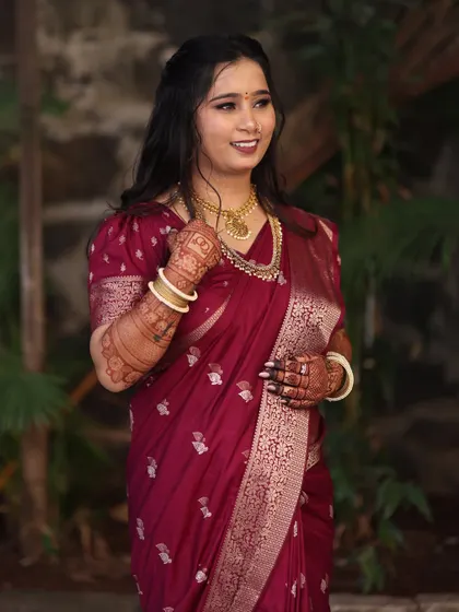 A confident and happy bride. Her makeup is a balance of soft glam and natural elegance, perfect for her engagement celebration.