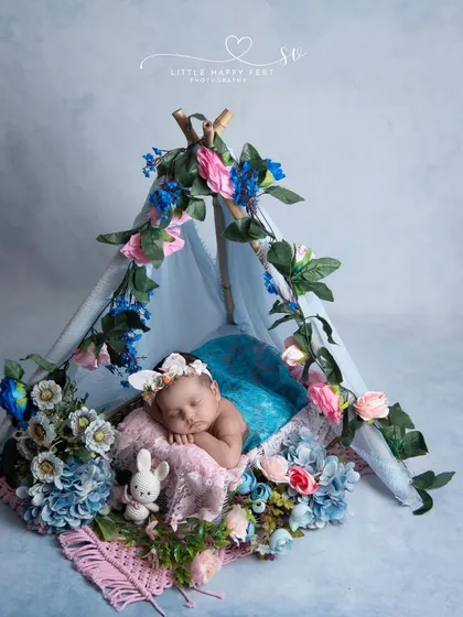 A floral teepee is a perfect little haven for a newborn. The mix of pink and blue flowers creates a balanced and beautiful color story.