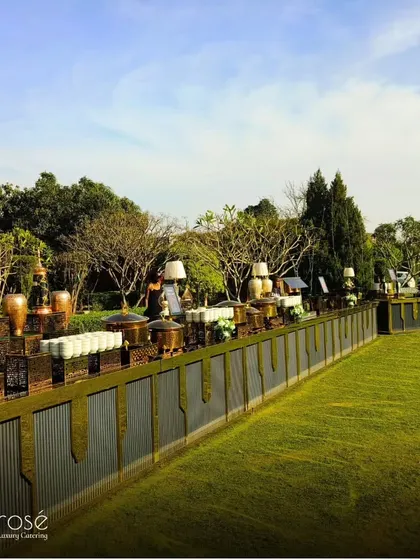 A wide shot of an outdoor buffet line, showcasing the impressive length and elegant setup. We have the capacity and expertise to handle large-scale events with flawless execution.