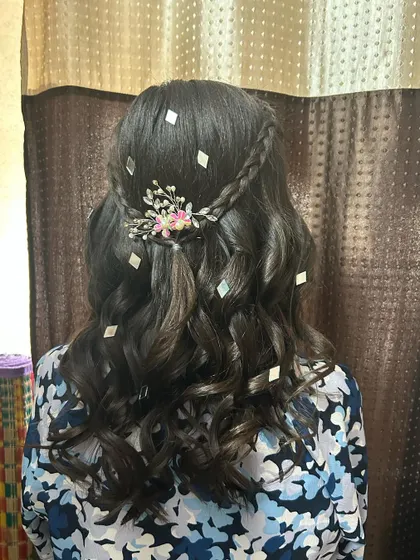 Another angle of the cocktail hairdo with braids and diamond accessories.