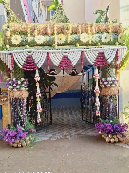 A straight-on shot of the traditional entrance, highlighting the beautiful archway created with woven jasmine and rose petals.