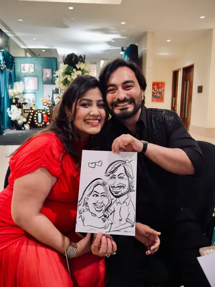 This happy couple proudly displays their caricature, a fun memento from the event they attended. I love capturing the connection between two people in my drawings.