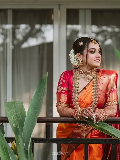 A beautiful portrait of the bride on a balcony. The makeup is designed to look stunning in natural light, with a focus on a radiant, long-lasting finish that feels comfortable all day.