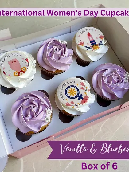 Celebrating girl power with our International Women's Day cupcakes. This box of vanilla and blueberry cupcakes features empowering messages and designs.