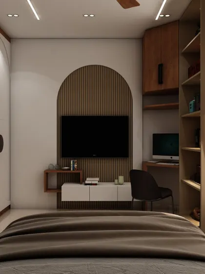 The TV unit in this bedroom is framed by an arched niche with wood fluting, complemented by a compact study desk and built-in shelving.