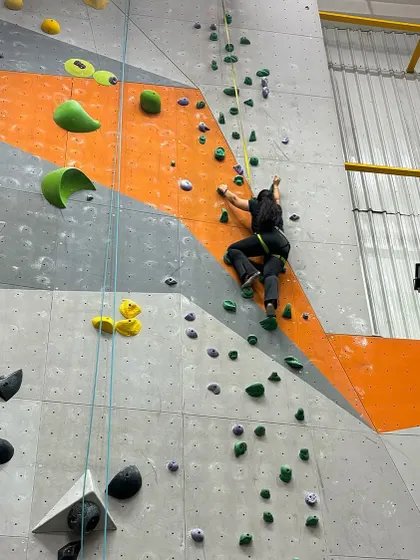 A female climber navigates a challenging top-rope route during the CPL. We require at least one female member per team to ensure inclusive and diverse competition.