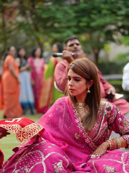 A beautiful shot of the client during her Karwa Chauth rituals, looking elegant in her pink lehenga.