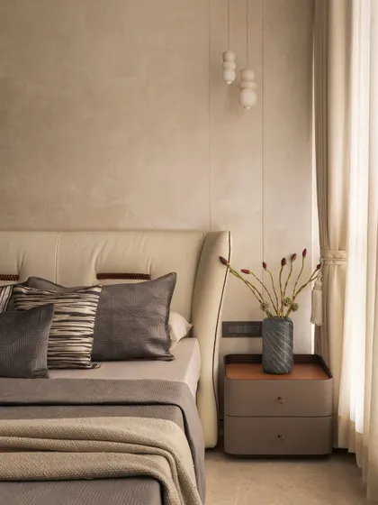 Beige is never boring when done right. In this room, I layered various shades and textures of grey and beige, from the upholstered headboard to the throw pillows and linens, to create a sophisticated, monochrome look.