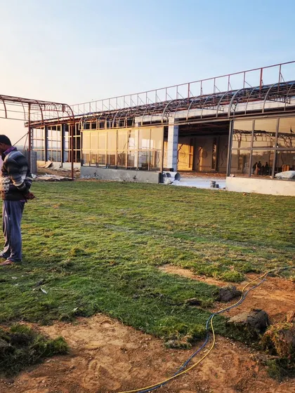 The expansive lawn of a commercial venue after our turf installation, creating a vast green space perfect for large events and gatherings.