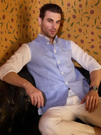 The subtle texture of the pastel blue waistcoat adds a layer of visual interest. It's a piece that is both classic and contemporary.
