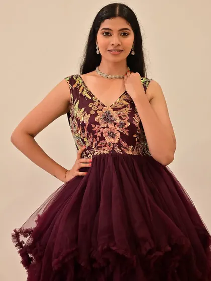A full look at the embroidered gown, with makeup that enhances the model's features without competing with the detailed dress.