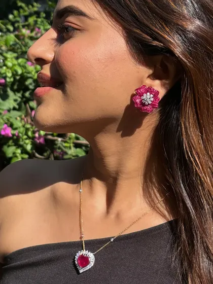 A beautiful ruby floret earring, where each petal is a carefully set gemstone, centered with a brilliant diamond. This is a perfect example of wearable art.