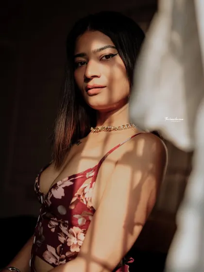 A warm, sunlit portrait with a direct and engaging gaze. The shadows add depth and dimension, making the image more captivating.
