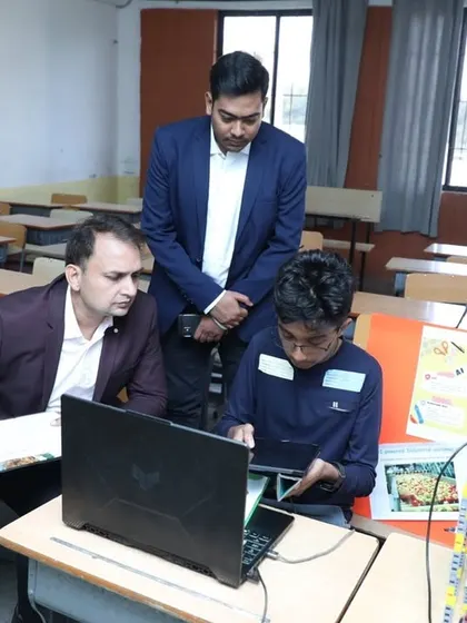 Our founder and an instructor review a student's project. We believe that while traditional education is important, the ability to create and innovate is what truly sets kids apart.