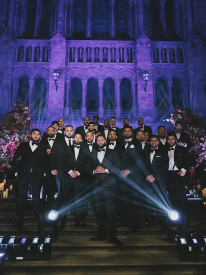 The groomsmen lined up on the grand staircase at the Natural History Museum. This is a great shot of the crew, looking sharp and ready to celebrate.