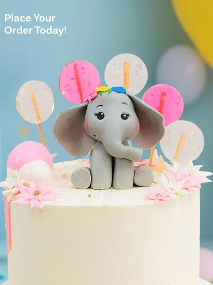 A close-up of the adorable elephant with a tiny flower on its head, ready for a party.