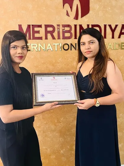 A happy graduate holding her certificate, a symbol of her new professional status.