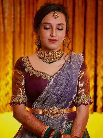 A tranquil bridal portrait. The bride's calm expression and the warm, soft lighting create a moment of peaceful contemplation.