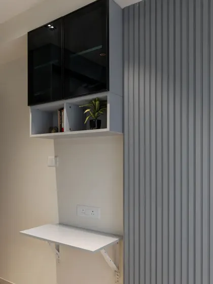 This bedroom features a space-saving, wall-mounted study or utility table that can be folded down when not in use.