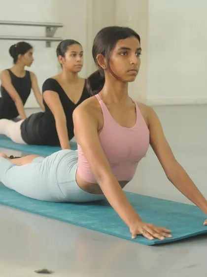 In our Stretch & Beyond class, we use mats for floor exercises that target key muscle groups. Here, students work on back flexibility and strength with a controlled cobra pose.