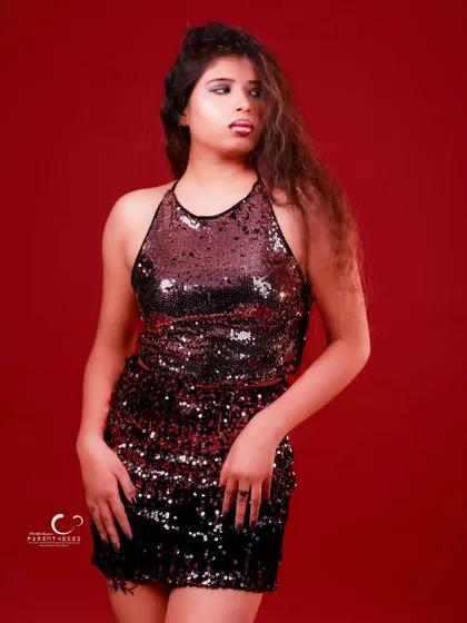 A classic standing pose that is both elegant and powerful. The red background makes the black sequins stand out beautifully.