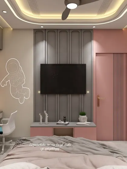 This kids' room has a fun, space-themed touch with an astronaut decal on the wall. The TV unit is simple and functional, and the pink and grey color scheme is modern and playful.
