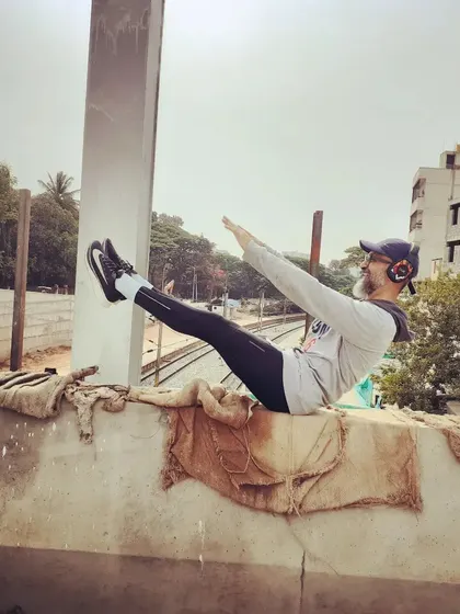 The Pilates teaser is a classic core challenge. I like to do it anywhere, even on a wall overlooking the city. It proves that all you need is your own body to build serious strength.