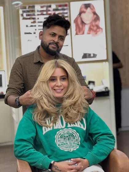 Here I am with the client, putting the finishing touches on her trendy soft wolf cut and blonde color. A great style is a team effort.