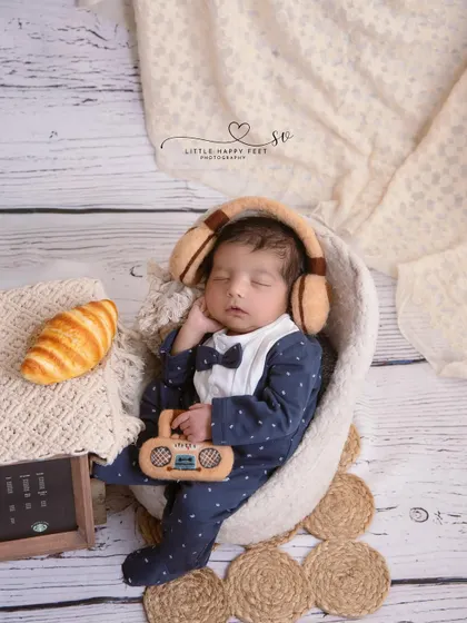 Chilling with some tunes and a croissant. This little gentleman in his bowtie and suit is the picture of cool, showing that even newborns can have style.