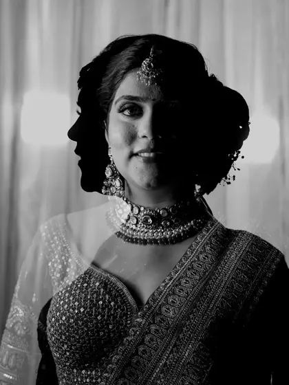A creative double exposure portrait, blending the bride's profile with her forward-facing portrait for an artistic effect.