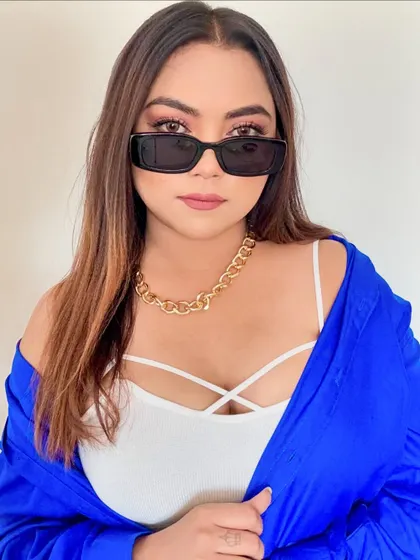 A stylish portrait in a blue shirt and sunglasses.