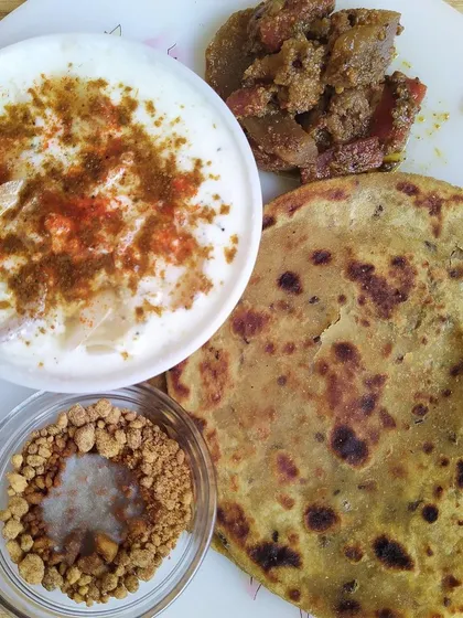 A wholesome plate featuring my sweet and savory Mix Veg Achaar with a sattu ka paratha and raita. This pickle is a crowd pleaser, filled with gobi, gajar, shalgam, and muli.