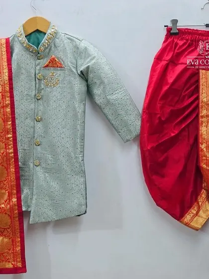 A complete traditional outfit for boys. This set includes a light green kurta, a red silk dhoti, and a matching red and gold angavastram or shawl.