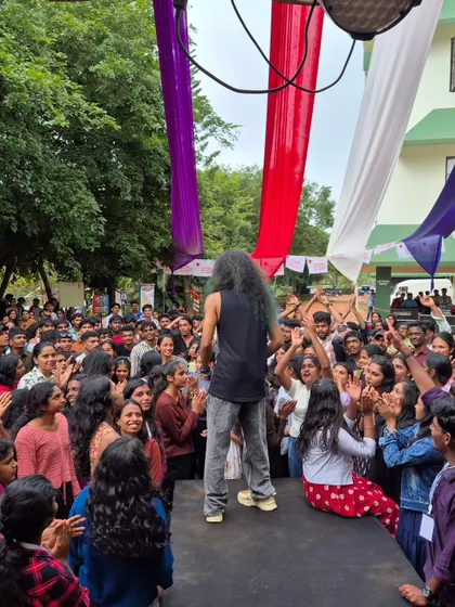 On a small stage, right in the middle of the action, with students dancing and cheering all around me.