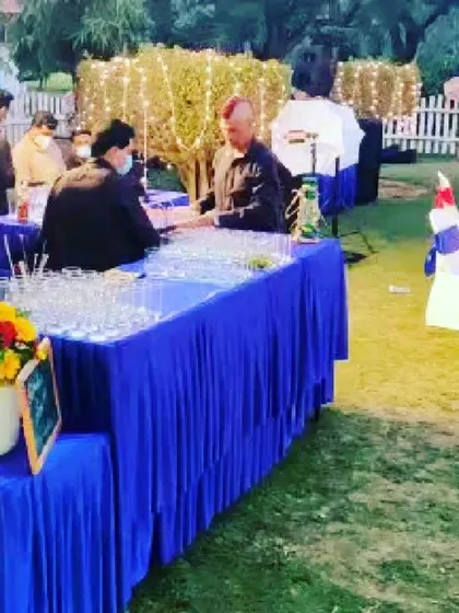 A dedicated beverage counter at an outdoor mehandi function. We can set up separate stations for drinks, starters, and main courses to ensure smooth guest flow.