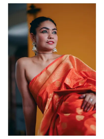 A similar portrait from a different angle, showing off the beautiful drape of the saree and the model's elegant posture.