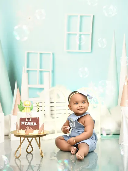 A moment of calm before the cake. This first birthday setup with a custom cake is ready for the celebration to begin.