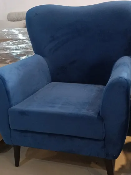 A classic armchair in a rich blue velvet fabric. This bespoke piece can be customized in various colors and fabrics to perfectly match your home's interior design.