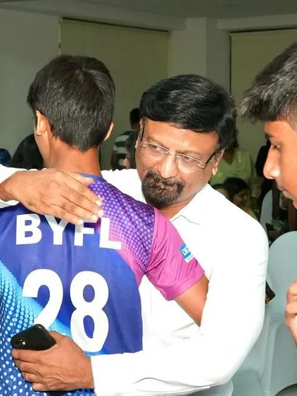 A candid moment of a father hugging his son at our recognition day event.