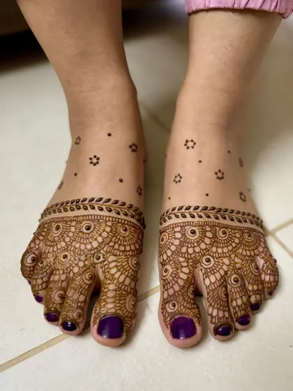 A minimal feet design with detailed work covering the toes like jewelry, and scattered floral dots.